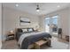 Furnished bedroom with wood bed frame, ceiling fan, and hardwood floors at 10912 Mobberley Cir, Orlando, FL 32832