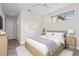 Cozy bedroom with a neutral decor, wood floors, a comfortable bed, and a large window at 10912 Mobberley Cir, Orlando, FL 32832