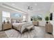 Comfortable bedroom featuring a ceiling fan, area rug, and natural light at 10912 Mobberley Cir, Orlando, FL 32832