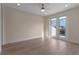 Unfurnished bedroom with ceiling fan, hardwood floors, and patio doors at 10912 Mobberley Cir, Orlando, FL 32832