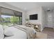 Comfortable bedroom with access to a covered balcony overlooking a beautiful green space at 10912 Mobberley Cir, Orlando, FL 32832