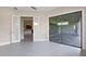 Bonus room featuring tile flooring, neutral paint, and sliding glass doors to the outside patio area at 10912 Mobberley Cir, Orlando, FL 32832