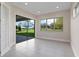 Bonus room featuring light walls, tiled floors, and a sliding glass door overlooking the lawn at 10912 Mobberley Cir, Orlando, FL 32832