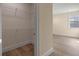 Walk-in closet with wire shelving, adjacent to a room with wood flooring and ample natural light at 10912 Mobberley Cir, Orlando, FL 32832