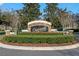 Chatsworth community entrance sign featuring stone accents, dark signage, and mature landscaping at 10912 Mobberley Cir, Orlando, FL 32832