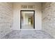 Spacious entryway with stone walls leading into a home with natural light at 10912 Mobberley Cir, Orlando, FL 32832