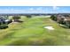 View of a green golf course with a sand trap on a sunny day at 10912 Mobberley Cir, Orlando, FL 32832
