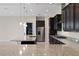 Modern kitchen with dark cabinets, granite countertops, and stainless steel appliances at 10912 Mobberley Cir, Orlando, FL 32832