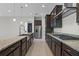 Modern kitchen boasts dark wood cabinets, granite counters, and professional-grade appliances at 10912 Mobberley Cir, Orlando, FL 32832