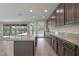 Modern kitchen with granite countertops, dark cabinets, and stainless steel appliances offering a view of the outdoor patio at 10912 Mobberley Cir, Orlando, FL 32832