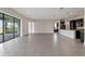 Expansive living room with tile flooring and a large sliding glass door to backyard at 10912 Mobberley Cir, Orlando, FL 32832