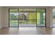 Bright living room featuring wood floors and sliding glass doors to the outdoor patio, with views of the lush landscape at 10912 Mobberley Cir, Orlando, FL 32832