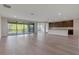 Open-concept living room with hardwood floors and view of the balcony and back yard at 10912 Mobberley Cir, Orlando, FL 32832