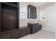 Mud room with dark wood cabinets and granite countertop, great storage and organization at 10912 Mobberley Cir, Orlando, FL 32832
