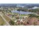 Aerial view of homes with a red outline, highlighting its location near a beautiful lake at 112 Fairway Cir, Umatilla, FL 32784