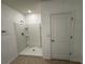 Modern bathroom featuring a walk-in shower, white fixtures, and tile flooring at 1463 Riverboat Dr, Kissimmee, FL 34744