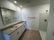 Primary bath with dual sinks, granite counters, tile floor, and a walk-in shower at 1463 Riverboat Dr, Kissimmee, FL 34744