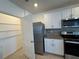 Well-equipped kitchen with stainless steel appliances, granite counters, and a pantry for ample storage at 1463 Riverboat Dr, Kissimmee, FL 34744