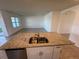 Spacious kitchen with a granite island and stainless steel appliances seamlessly connects to living area at 1463 Riverboat Dr, Kissimmee, FL 34744