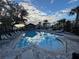 Relaxing community pool with clear blue water, sun loungers, and a hot tub for residents' enjoyment at 1463 Riverboat Dr, Kissimmee, FL 34744