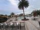 Resort-style community pool with ample seating, umbrellas, and well-maintained surrounding landscaping at 1463 Riverboat Dr, Kissimmee, FL 34744