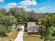 Aerial view of house featuring a car port, driveway and trees at 1510 Oak Ln, Casselberry, FL 32707