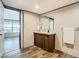 Bathroom with wood-look floors, a vanity with a sink, and a mirror at 1510 Oak Ln, Casselberry, FL 32707