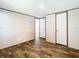 A cozy bedroom with modern flooring and neutral wall colors with doors at 1510 Oak Ln, Casselberry, FL 32707