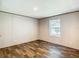 A bright bedroom with plank flooring, natural light, and neutral wall colors at 1510 Oak Ln, Casselberry, FL 32707