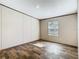 A bright bedroom showcasing plank flooring, natural light, and neutral wall colors at 1510 Oak Ln, Casselberry, FL 32707