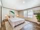 Bedroom featuring wood-look floors, natural light, and a large cozy bed with throw pillows at 1510 Oak Ln, Casselberry, FL 32707