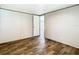 An empty bedroom features neutral walls, plank flooring, and a door to another room at 1510 Oak Ln, Casselberry, FL 32707