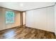 An airy bedroom features natural light and modern wood-look flooring at 1510 Oak Ln, Casselberry, FL 32707