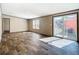 Bright living room with wood-look flooring and a sliding glass door to a patio at 1510 Oak Ln, Casselberry, FL 32707