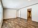 Open-concept room with wood-look floors leading into the kitchen and bathroom at 1510 Oak Ln, Casselberry, FL 32707