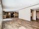 Open floor plan with a living area flowing into the kitchen, featuring wood-look flooring at 1510 Oak Ln, Casselberry, FL 32707