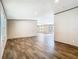 Spacious living room featuring wood-look flooring, neutral walls, and ample natural light at 1510 Oak Ln, Casselberry, FL 32707