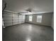 An empty garage space, freshly painted with epoxy flooring and updated lighting at 1527 Dingens, Windermere, FL 34786