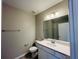 Bathroom featuring a vanity, toilet, and a large mirror at 15352 Burgtheater Dr, Winter Garden, FL 34787