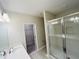 Bright bathroom showcasing tiled shower with glass door, vanity, and walk-in closet at 15352 Burgtheater Dr, Winter Garden, FL 34787