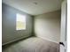 A bedroom featuring neutral walls, carpet, a window, and white trim at 15352 Burgtheater Dr, Winter Garden, FL 34787