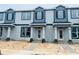 New two-story townhomes with modern gray exteriors and covered front porches at 15352 Burgtheater Dr, Winter Garden, FL 34787