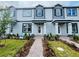 Charming light blue townhome exterior featuring well-manicured landscaping and a welcoming entryway at 15352 Burgtheater Dr, Winter Garden, FL 34787