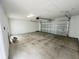 Unfinished garage with an open door showing an exterior driveway at 15352 Burgtheater Dr, Winter Garden, FL 34787
