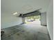 Spacious, unfinished garage with an open door showing the exterior driveway at 15352 Burgtheater Dr, Winter Garden, FL 34787
