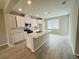Contemporary kitchen featuring a center island, stainless steel appliances, and bright natural light at 15352 Burgtheater Dr, Winter Garden, FL 34787