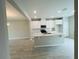 Modern kitchen with white cabinetry, a center island, and a seamlessly connected dining area at 15352 Burgtheater Dr, Winter Garden, FL 34787