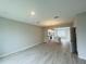 Bright, open-concept living area with modern flooring and recessed lighting leading into the kitchen at 15352 Burgtheater Dr, Winter Garden, FL 34787