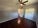 Bedroom featuring hardwood floors, a closet, and neutral wall paint at 1703 Doreen Ave, Ocoee, FL 34761