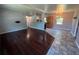 The open-concept living space features dark wood floors that flow into a tile kitchen with bar seating at 1703 Doreen Ave, Ocoee, FL 34761